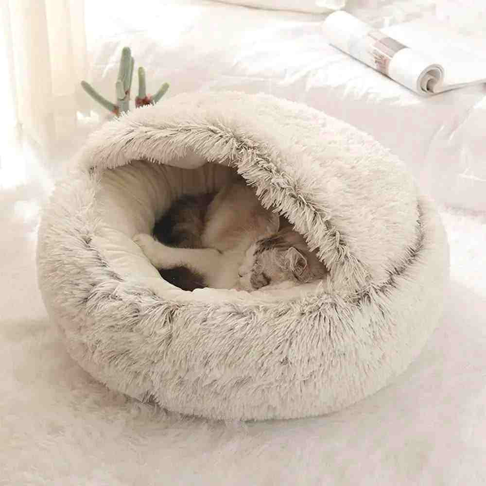 Soft plush pet bed with raised edges and cozy burrow design featuring a sleeping cat inside