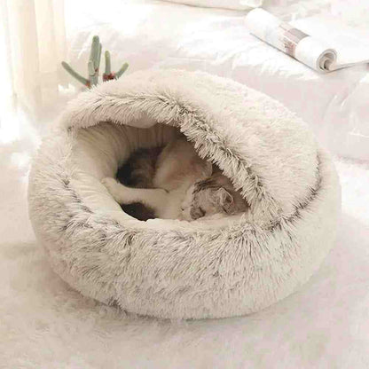 Soft plush pet bed with raised edges and cozy burrow design featuring a sleeping cat inside